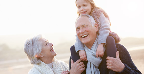 Grandparents holding a grandchild